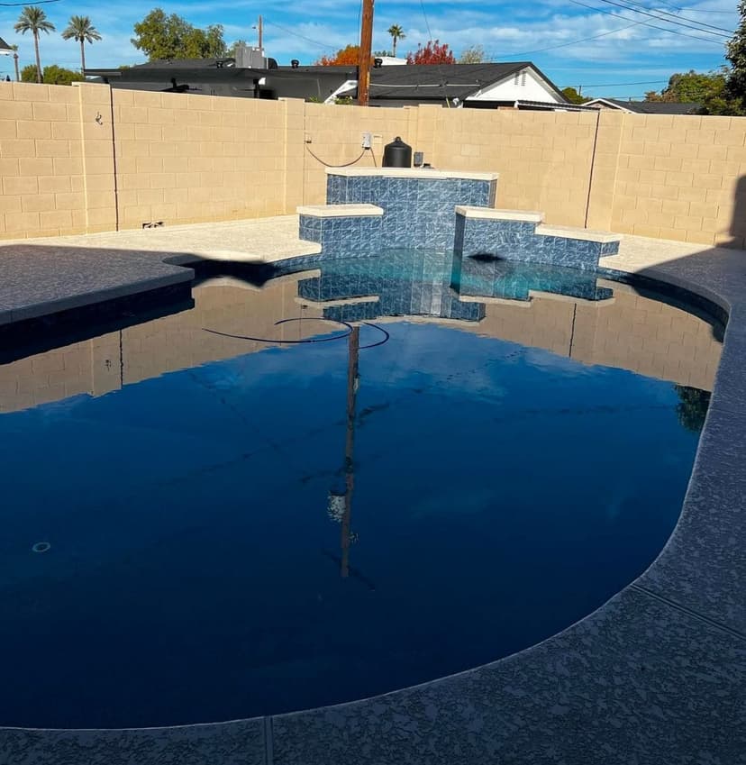 Pool with travertine deck and glass tile, real project